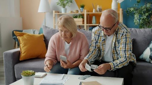 Elderly couple reviewing documents together at home.